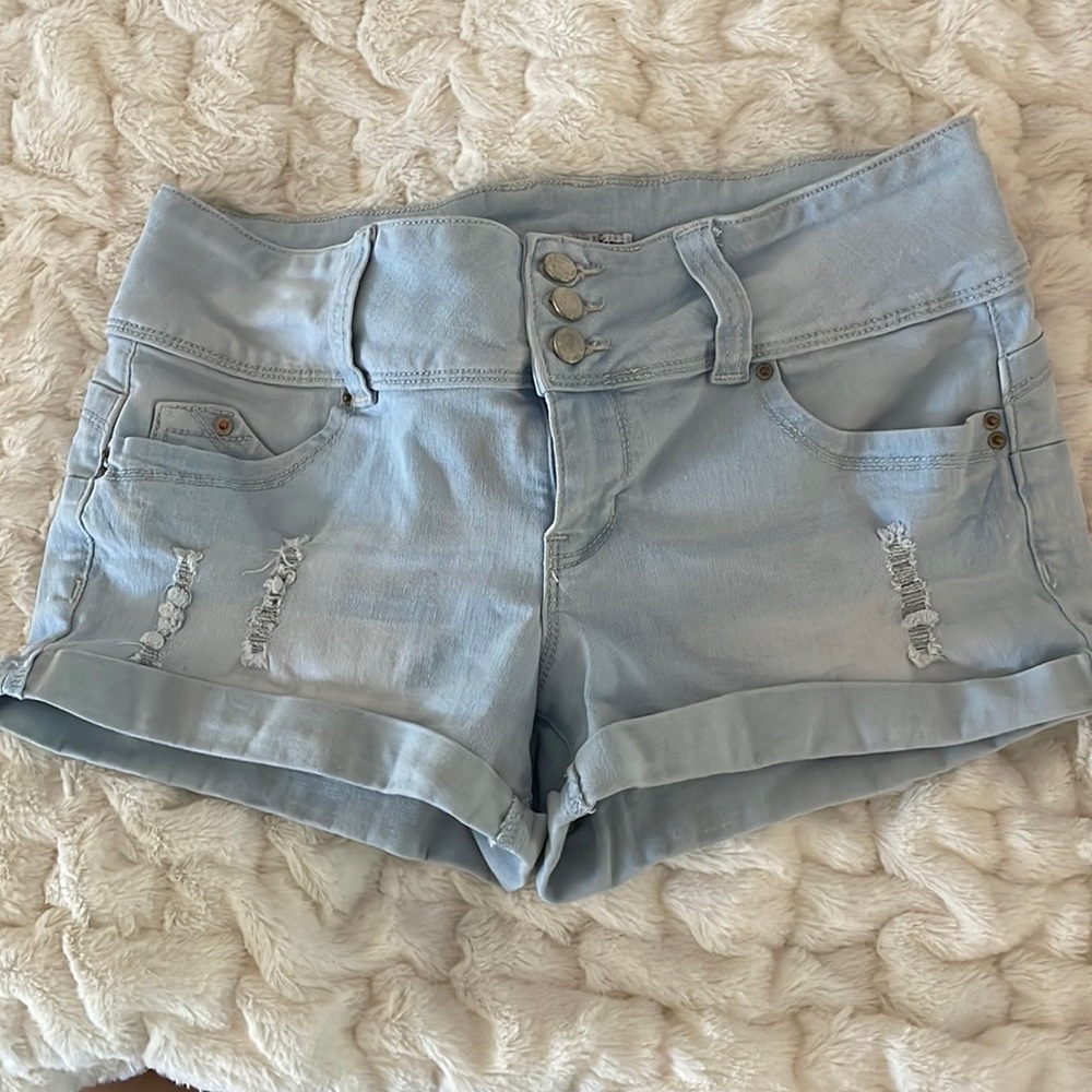 Light wash, distressed, mid rise shorts. Size 7